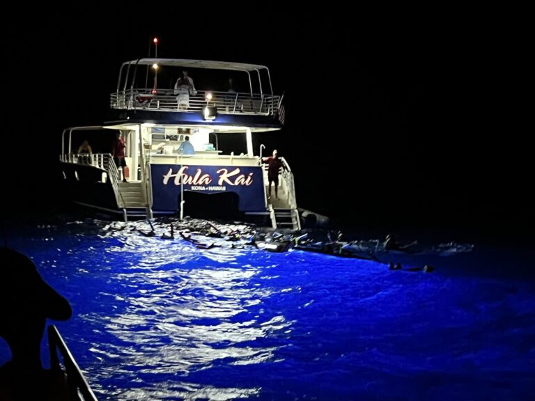 Snorkelers at Kona in front of a boat