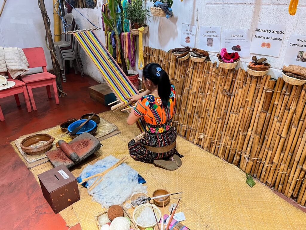 Woman demonstrating backstrap looming technique in San Juan la Laguna